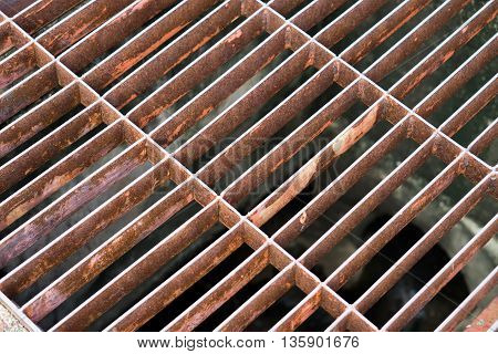rust steel sewer cover or sewage drain cover, on public road