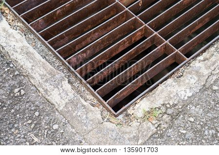 rust steel sewer cover or sewage drain cover, on public road