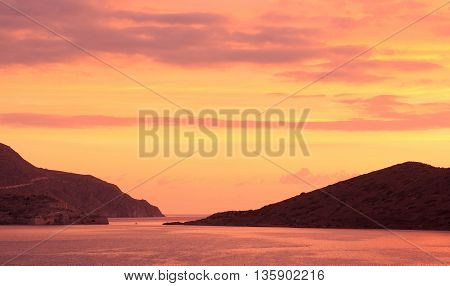 Mirabello Bay. Colorful sunrise. View from the island of Crete. Greece