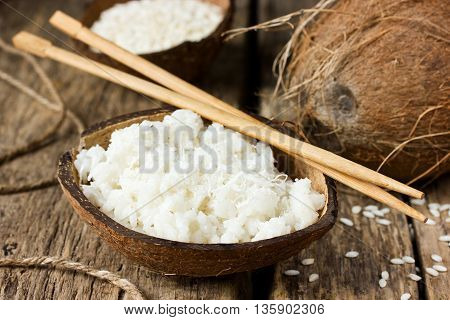 Coconut pudding with jasmine rice in half coconut shell selective focus