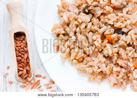 Vegetarian pilaf of red rice devzira with mushrooms and vegetables