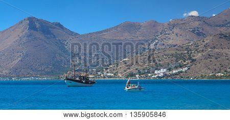 two ships in the Gulf of Mirabello mountains in the background