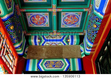 Beijing China - May 5 2005: Hand-painted wooden ceiling at the Wenchang Gallery in traditional red green and blue colours at the Summer Royal Palace