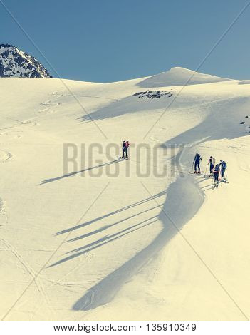 Skiers ascending a mountain slope. Ski touring in Malta valley, Austria.