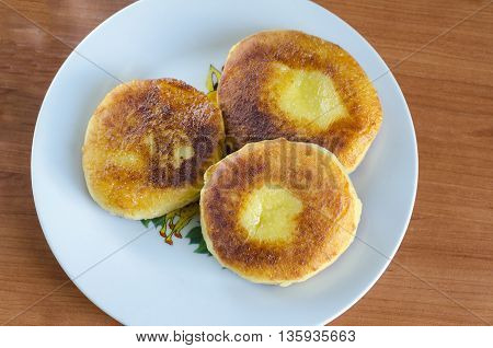 Grandma's curd pancakes with their hands on the country