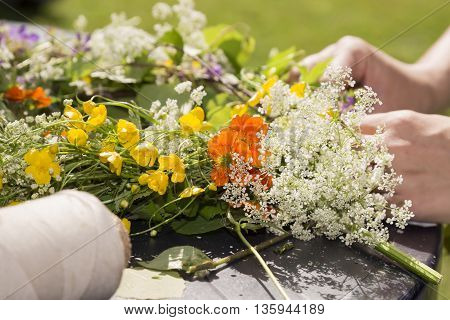 Woman Making a Swedish Midsummer Head Creation.