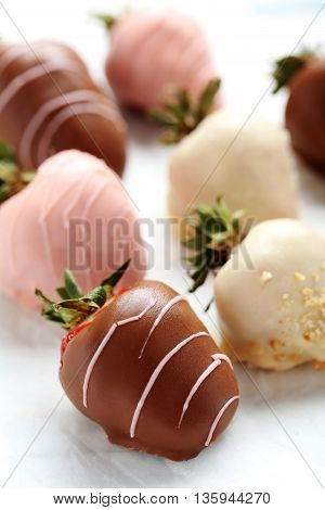 Strawberries Covered In Chocolate On A White Pergament