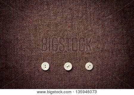 background of wool fabric and three buttons