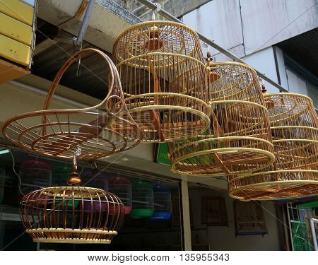 traditional Thai handmade bamboo bird cages hanging in Songkhla pet shop, Thailand