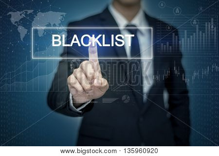 Businessman hand touching BLACKLIST button on virtual screen