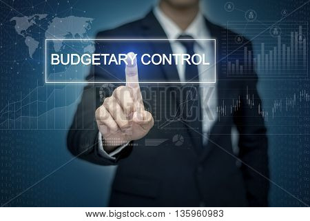 Businessman hand touching BUDGETARY CONTROl button on virtual screen