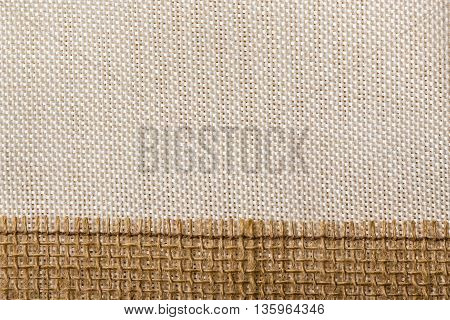 Jute bagging ribbon on bright textile material sack cloth background