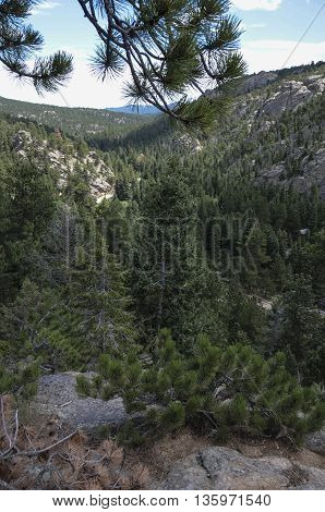 A view down into a valley from atop a mountain.