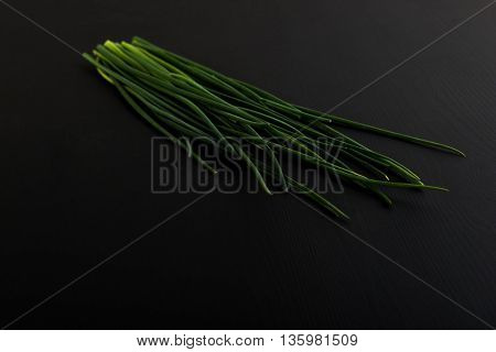Fresh green chives on dark board