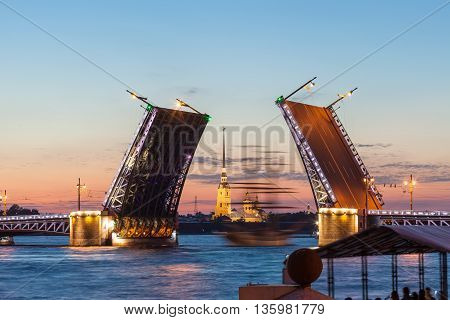 Defocused sailboat under the Palace bridge at night. Saint Petersburg, Russia