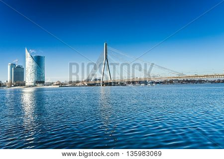 A view of the buildings and Vansu bridge on the banks of the Daugava River in Riga, Latvia at winter