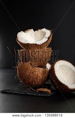 Stack of coconut shells on dark background
