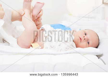 Woman changing the diaper of a newborn