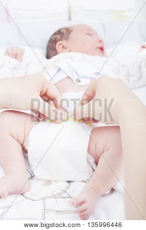 Woman changing the diaper of a newborn