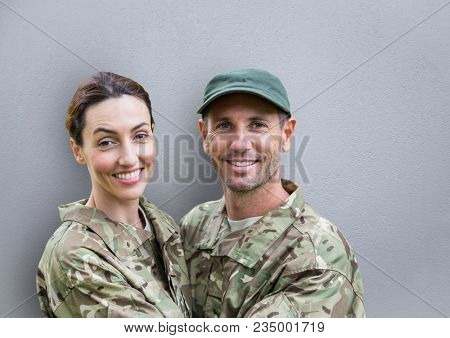 soldiers couple smiling. concrete wall