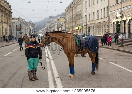 Kiev, Ukraine - December 28, 2017: Girl Invites City Residents Will Sweep On A Horse To Output A Day
