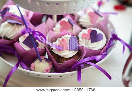 White Plate With Chocolate Cakes With White Cream, Pink And Purple Decoration Hearts In Moscow Resta