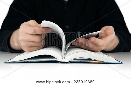 Men's Hands Flipping Through The Pages Of The Book