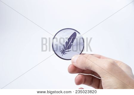 Cryptocurrency Hand Is Holding A Feathercoin In A Composition