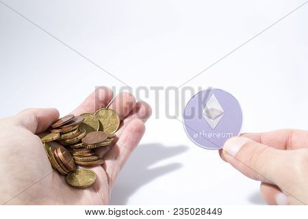 Cryptocurrency Hand Is Holding Euro Coins And An Etherum In A Composition