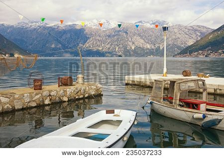 Cloudy Mediterranean Landscape With Snow-capped Mountains And Fishing Boats In A Small Harbor. Monte