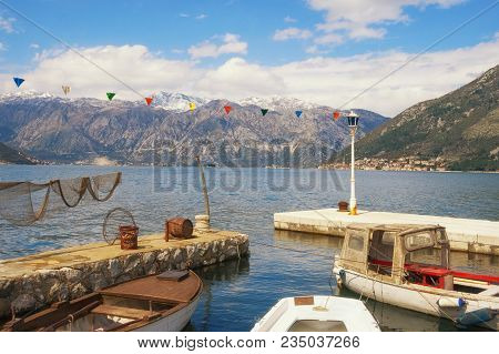Sunny Mediterranean Landscape With Snow-capped Mountains And Fishing Boats In Small Harbor. Monteneg