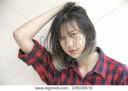 Portrait Of Asian Girl With Looking At Camera On White Background.