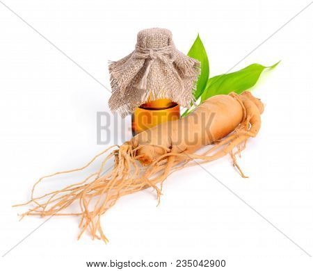 Ginseng Root With Pharmaceutical Bottle And Leawes. Isolated.
