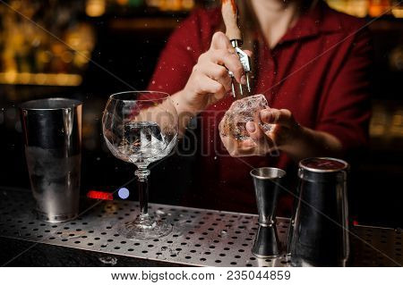 Professional Bartender Breakin An Ice Cube For Prepare A Fresh Cocktail At The Steel Bar Counter