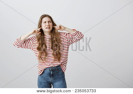 When This Annoying Noise Will Stop. Displeased Bothered Young Woman With Tattoo On Arm Grimacing Fro