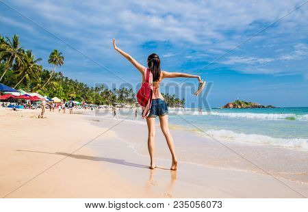 Mirissa Beach, Sri Lanka - JAN 3, 2017:  Tourists walking on the sand while enjoying the view across the wonderful beach of Mirissa on Jan 3, 2017. Sri Lanka.