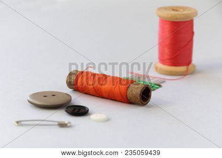 Safety Pin, Buttons, Coil With Threads On A Light Background. Selective Focus