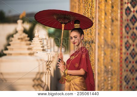 Beautiful Women In Red Tradition Breast Cloth Dress With Red Umbrella Stand  In Temple.