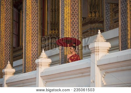 Beautiful Women In Red Tradition Breast Cloth Dress With Red Umbrella Stand  In Temple.