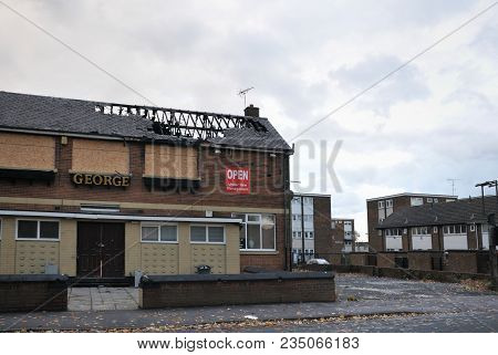 Leeds, England - September 24, 2017: A Closed Public House Stands Derelict And Boarded On A Housing 