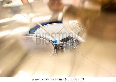 Drummer Playing On Drum Set Top View. Live Music Concert, Band During Performance. View And Look Thr