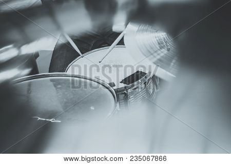 Drummer Playing On Drum Set Top View. Live Music Concert, Band During Performance. View And Look Thr