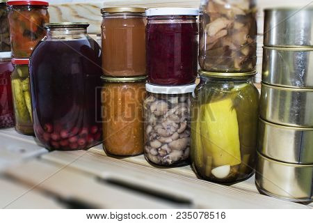 Storage Shelves In Pantry With Homemade Canned Preserved Fruits And Vegetables.