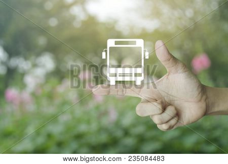 Bus Flat Icon On Finger Over Blur Pink Flower And Tree, Business Transportation Service Concept
