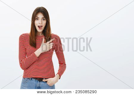 You Never Guess What I Saw. Amazed Impatient Good-looking Woman In Striped Blouse, Pointing At Upper