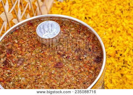Flowers And Holy Water And Yellow Background.