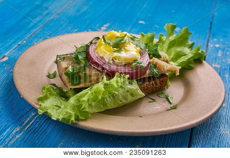 Sol Over Gudhjem - Danish Dish, An Open Sandwich With Rugbrod, Smoked Herring, Chives And A Raw Egg 