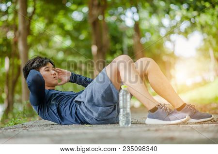 Sit Ups - Fitness Cross Fit Man Doing Sit-ups On Beach Training And Working Out With High Impact. Fi