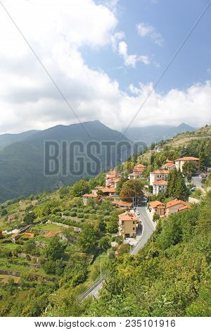 The City Of Trior, Italy. View Of The Houses On The Mountain And The Green Forest. Alpine Mountains.