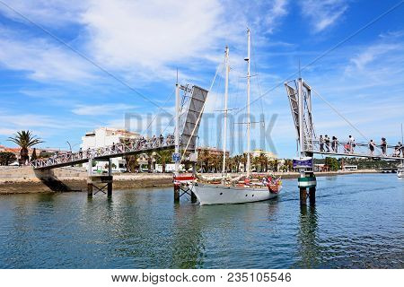 Lagos, Portugal - June 9, 2017 - Yacht Passing Through The Open Bascule Footbridge Along The River B